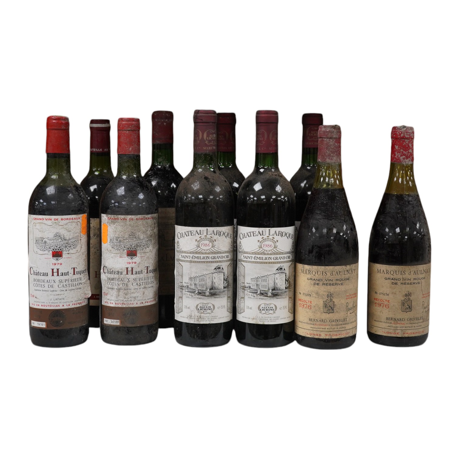 Ten bottles of French red wine to include Marquis D’Aulnay 1976 and Chateau Laroque 1986. Condition - storage unknown